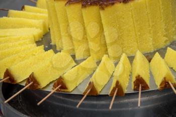 Glutinous Rice cake on skewers in famous shopping street in Tianjin
