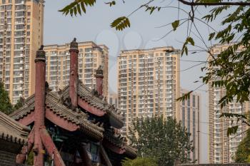 Roof of ancient Confucian Temple surrounded by apartment blocks