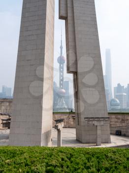 Monument to People's Heroes with Shanghai in background on misty day