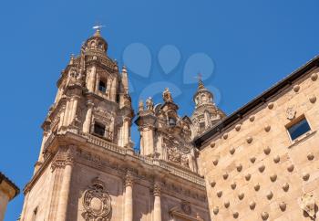 Ornate stone carvings on the Casa de la Conchas or shells and the Clericia church or cathedral in Salamanca