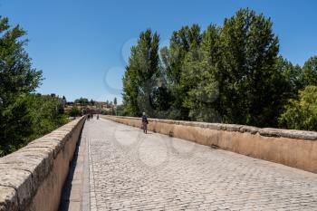 Cobbled surface of the old Roman Bridge leading away from the city of Salamanca in Spain