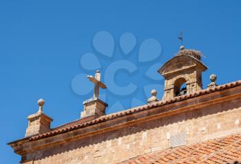 Detail of the bell tower and stork bird nest on the roof of San Pablo church in Salamanca Spain