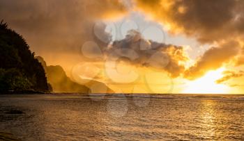 Sunset lights the receding cliffs of the NaPali coastline on north coast of Kauai in Hawaii