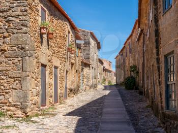 Old stone houses and narrow street in the ancient town of Castelo Rodrigo in Portugal