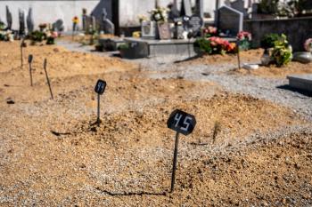 Markers for the positioning of new grave plots in the ground in a catholic cemetery in Portugal