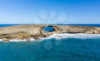 Sea arch or eroded cave in seabird sanctuary island off La'ie Point on Oahu, Hawaii