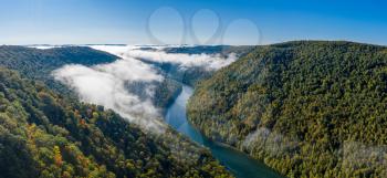 Aerial drone image of the Cheat River flowing through narrow wooded gorge in the autumn towards Cheat Lake near Morgantown, WV