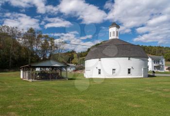 Well preserved white wooden round barn with cupola in Mannington, West Virginia