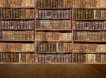 Defocused and blurred image of old antique library books on shelves with wooden floor for use in video conferencing background