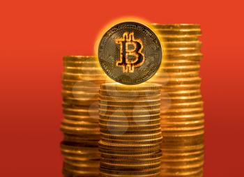 Single bitcoin on stack of golden coins and flame effect to show the cryptocurrency on fire with rising prices