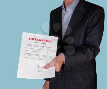Man in suit serving an eviction notice to a defaulting renter in due to missed rent in recession