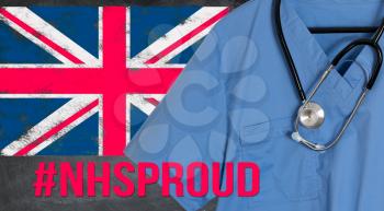 Blue doctor scrubs shirt and stethoscope hang in front of British flag. Illustration of medical staff being heroes in treating coronavirus epidemic