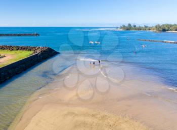 Aerial shot of traditional hawaiian canoes in the ocean off the North Shore town of Haleiwa