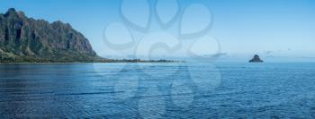 Panorama of Chinaman's hat off the coastline of Oahu in Hawaii from the Waiahole Beach Park