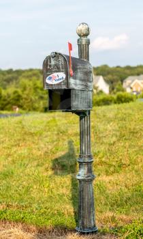 Metal mailbox for rural homes with I Voted sticker as concept for voting by mail or absentee ballot paper