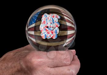 Senior caucasian man's hand holding glass fortune tellers globe or ball to predict the result of the USA presidential election