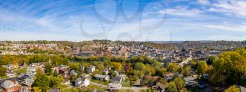 Aerial drone panoramic shot of the downtown area of Morgantown with the WVU campus in the fall