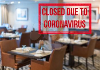 Defocused view of interior of an upmarket restaurant empty and closed due to coronavirus or covid-19