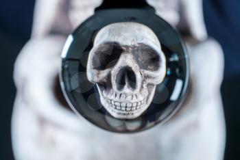 Human skull reflected in a glass reflecting ball or crystal ball as a concept for halloween