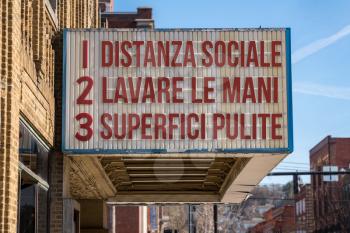 Italian movie cinema billboard with three rules to avoid the coronavirus epidemic. Translation, wash hands, maintain social distance, clean surfaces