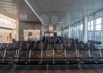 Empty seats at typical airport terminal due to travel restrictions because of coronavirus epidemic