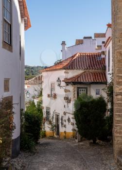 Steep street in the old medieval walled city of Obidos in Portugal