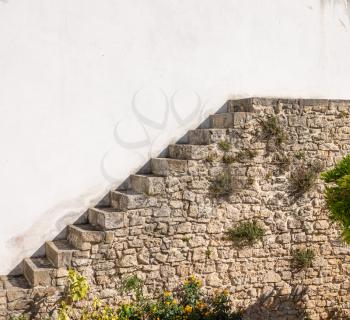 Unusual stone stairs leading nowhere in the old medieval walled city of Obidos in Portugal