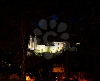 Evening view of the Portuguese town of Sintra with the Palacio Nacional de Sintra and its two chimneys in the foreground