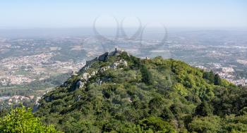 View of the Portuguese town of Sintra with the Moorish fortress or Castelo dos Mouros on the hilltop above the city