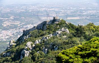 View of the Portuguese town of Sintra with the Moorish fortress or Castelo dos Mouros on the hilltop above the city