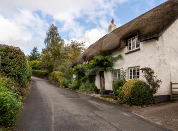 Stone home with thatched roof on small lane in the pretty Devon village of Dunsford