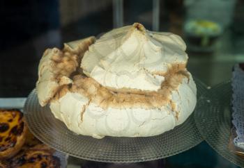 Display of large suspiros meringues in a bakery in Coimbra, Portugal