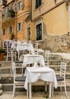 Tables and chairs of small neighborhood cafe in Kerkyra