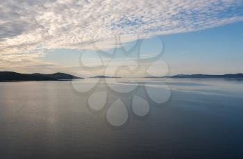 Calm Adriatic sea with islands off the coast of Croatia as ship approaches port of Zadar