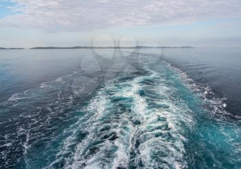 Ship wake as cruise ship turns past islands off the coast of Croatia approaching port of Zadar