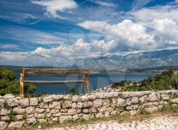 Bench on top of ruins of old Venetian fort above the coastal town of Novigrad in Croatia
