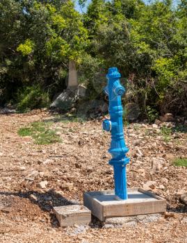 New installation of a blue fire hydrant in country road in Croatia