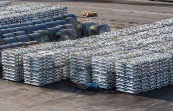 Ingots of aluminum and rolls of steel line the quayside in the Port of Koper in Slovenia