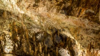 Stalactites and stalagmites underground in cave system in Postojna