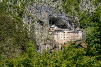 Famous castle of Predjama built into a cave in mountain in Slovenia