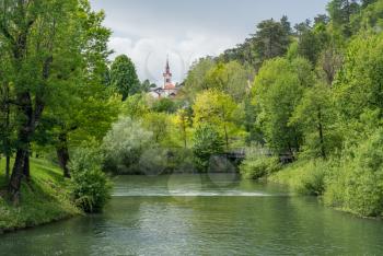 Calm and peaceful river in the park by Postojnska Jama in Slovenia