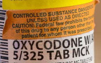 Oxycodone is the generic name for opoid pain killing tablets. Prescription bottle for pills and tablets with focus on the medication.
