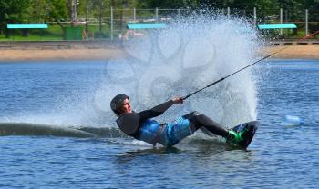 Water snowboard. The athlete with snowboard hold on to the rope and the boat accelerates.