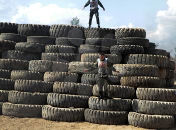 Athletes overcome a bunch of tires.