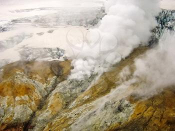 Geysers near the volcano. The nature of Kamchatka, a burnt volcano, an area near a volcano