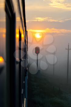 Passenger train rides against the sunset, Railway at sunset