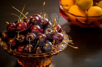 Cherry and apricot berries. Ripe fruit on the table