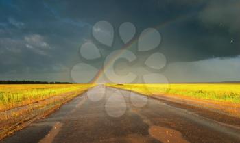 Landscape with country road and rainbow
