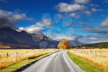 Mountain landscape with road and blue sky, Otago, New Zealand