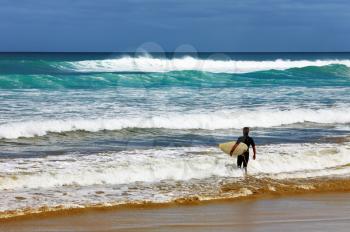 Surfer at the beach, Ninety Mile Beach, New Zealand
